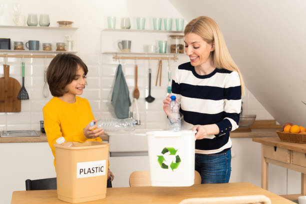 istock Mother and son recycling at home 1455459259