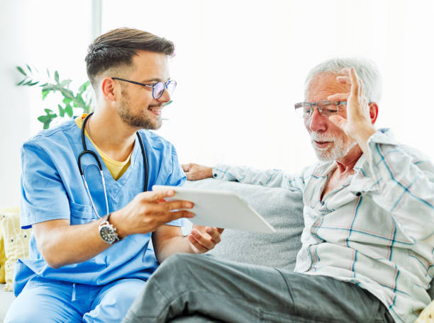istock nurse doctor senior care tablet computer technology showing caregiver help assistence retirement home nursing elderly man insurance 1455460508