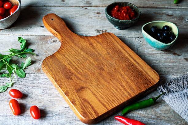 istock Cutting board with fresh vegetables and spices on a rustic wooden table. Top view with copy space 1455462153