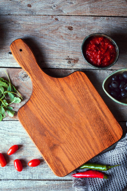 istock Cutting board with fresh vegetables and spices on a rustic wooden table. Top view with copy space 1455462164