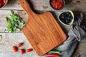 Cutting board with fresh vegetables and spices on a rustic wooden table. Top view with copy space