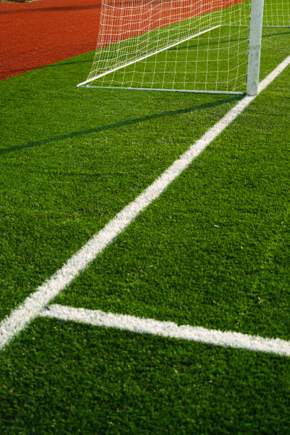 Close up shot of goal post with goal netting and goal line. stock photo