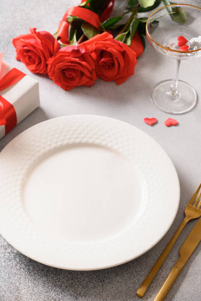 istock Valentine's day dinner with romantic gift and red roses. 1455463802