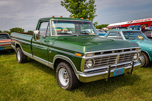 Iola, WI - July 07, 2022: High perspective front corner view of a 1974 Ford F150 Fleetside Pickup Truck at a local car show.