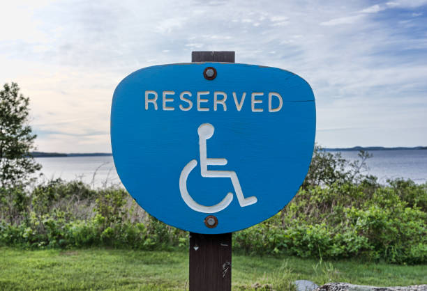 a handicapped reserved parking sign in a neighborhood park