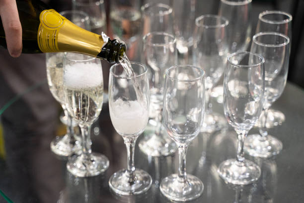 istock bartender pours champagne into a glass 1455466292