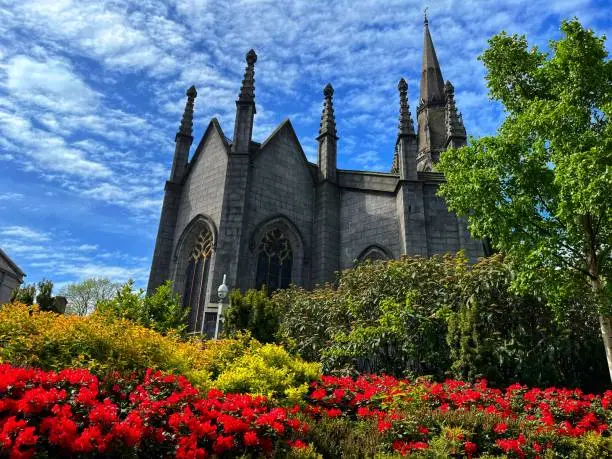 The Kirk of St Nicholas church in Aberdeen, Scotland taken in spring with full bloom flowers.