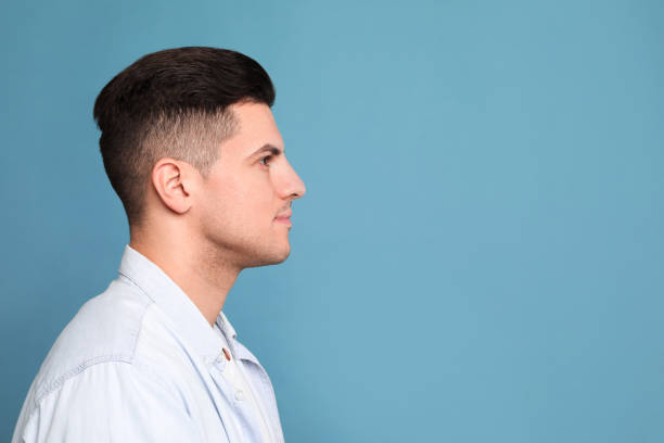 istock Profile portrait of man on light blue background. Space for text 1455466633