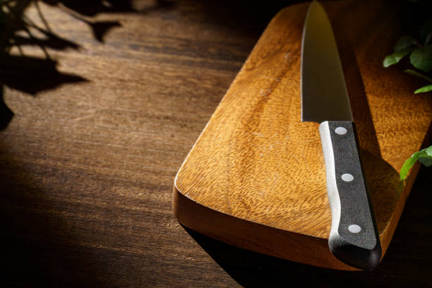 istock Kitchen knife and cutting board on wooden table 1455470089