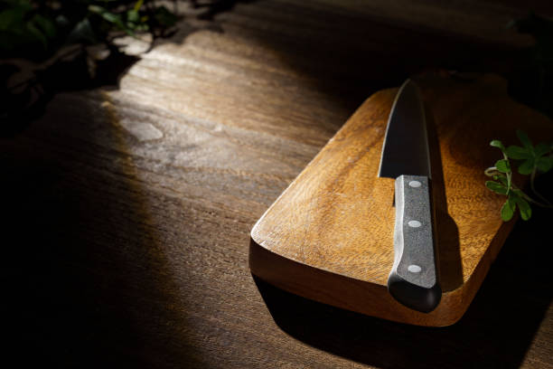 istock Kitchen knife and cutting board on wooden table 1455470095