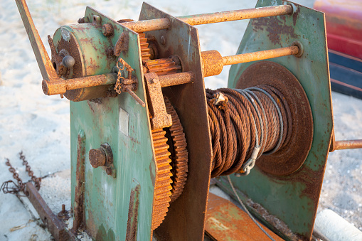 Detail of an old rusty cable winch with a transmission