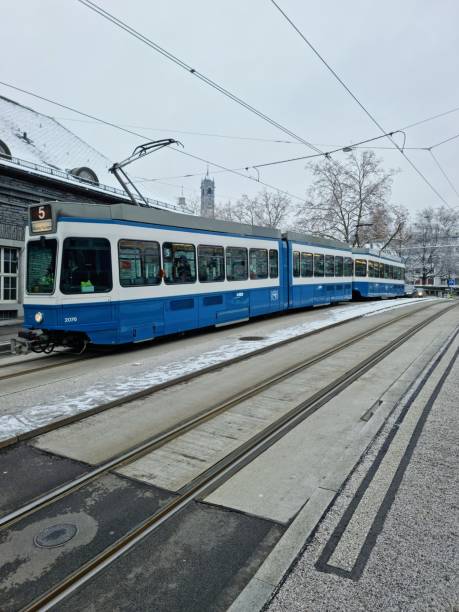 Zurich Enge Railway Sttaion. The first Building was opened in 1875, the new building was realized between 1925 and 1927. The station building is constructed of granite from the Ticino.The image shows the Railway Station during winter season with a Tram Nr.5.