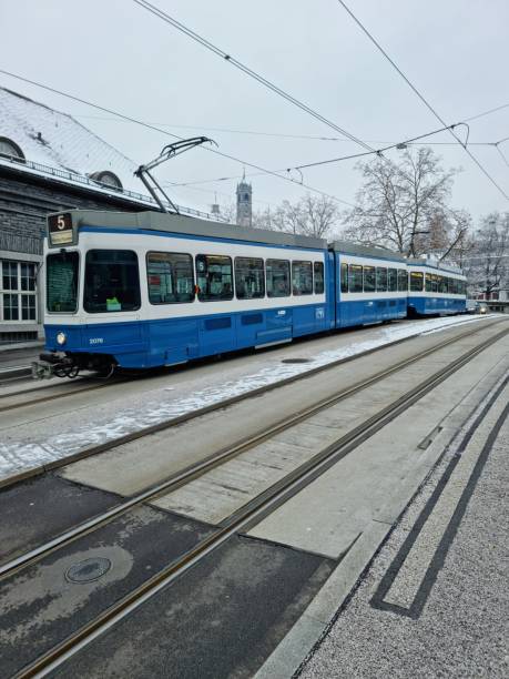 Zurich Enge Railway Sttaion. The first Building was opened in 1875, the new building was realized between 1925 and 1927. The station building is constructed of granite from the Ticino.The image shows the Railway Station during winter season with a Tram Nr.5.