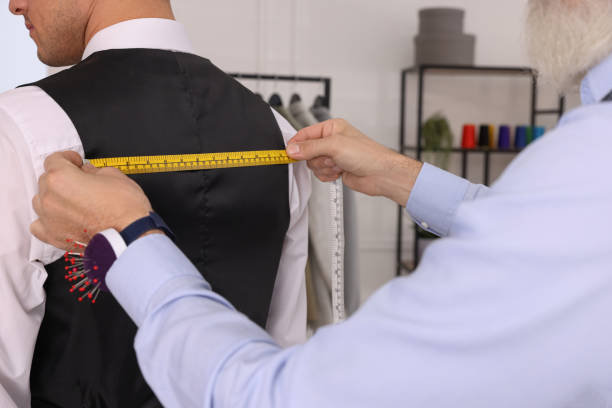istock Professional tailor measuring client's back width in atelier, closeup 1455472787