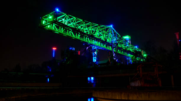 istock Illuminated steel factory with a crane in Germany 1455472919