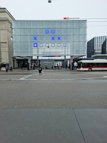 Entrance to the Railway Station St.Gallen with a small group of People. The image was captured during winter season.