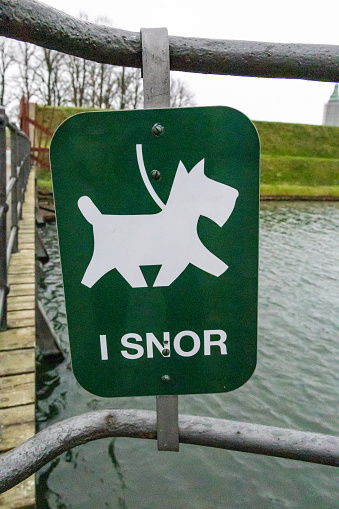 Helsngor, Denmark A sign in a park saying in Danish that dogs should be on a leash.