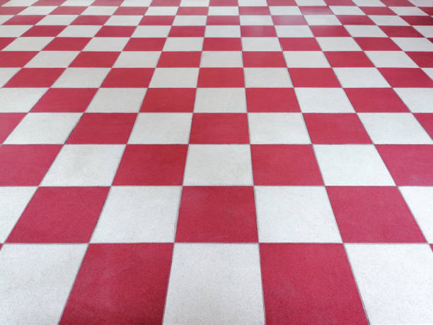 Red and white tiled floor symmetrical with grid texture in perspective view for background.Permanent tiled floor. red white square Made of floor ceramic material