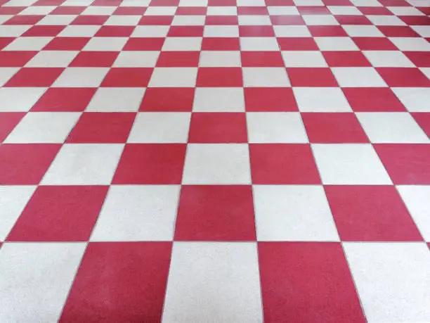 Photo of Red and white tiled floor symmetrical with grid texture in perspective view for background.Permanent tiled floor. red white square Made of floor ceramic material