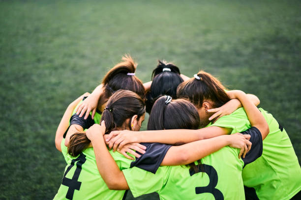 istock Girls soccer team discussing game plan in a huddle on field 1455476321