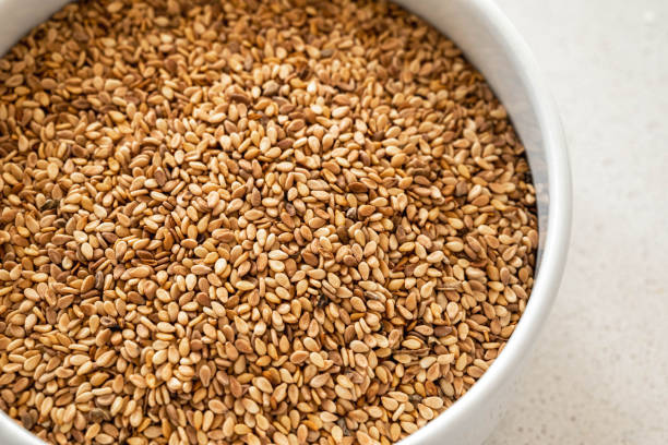 Roasted sesame seeds in white porcelain bowl.