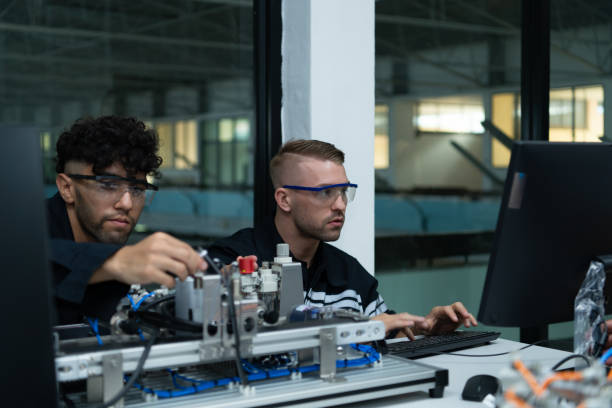 istock The robotic hand technology teacher is instructing new students on how to use electronic circuit boards and robotic hand commands for a variety of industrial applications. 1455480272