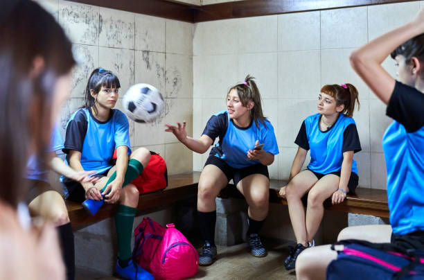 istock Girls soccer team in dressing room after practicing session 1455480341