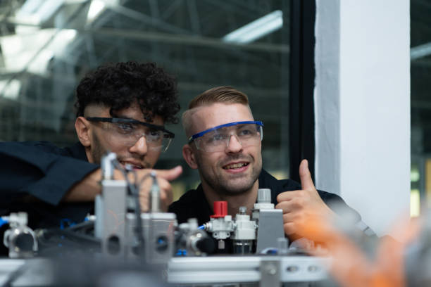 istock The robotic hand technology teacher is instructing new students on how to use electronic circuit boards and robotic hand commands for a variety of industrial applications. 1455480394
