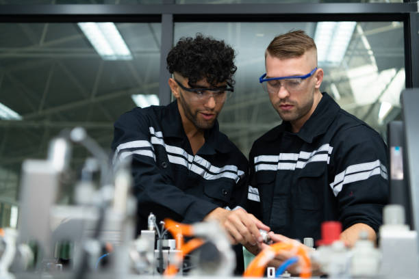 istock The robotic hand technology teacher is instructing new students on how to use electronic circuit boards and robotic hand commands for a variety of industrial applications. 1455480473
