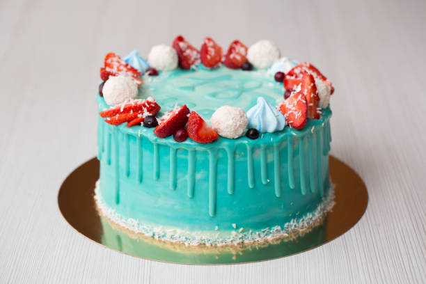 istock Cake turquoise and blue with strawberries, meringue and candies. 1455483706