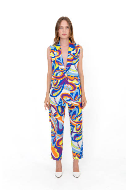istock Blonde girl on a white background, wearing a multi-colored and patterned jacket and trousers. 1455484231