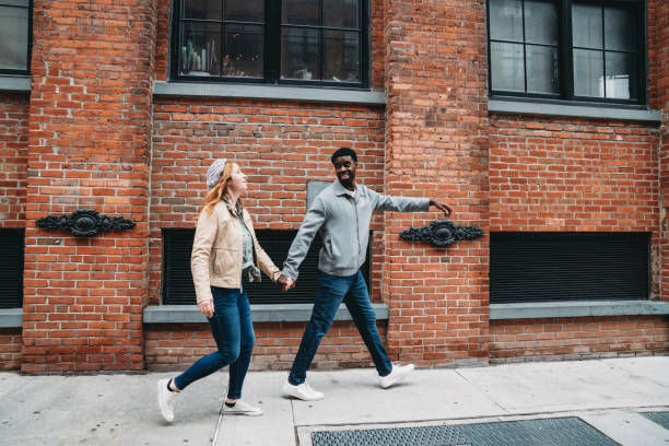 istock A multi-ethnic couple is walking in the street 1455484406