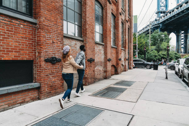 istock A multi-ethnic couple is walking in the street 1455484446