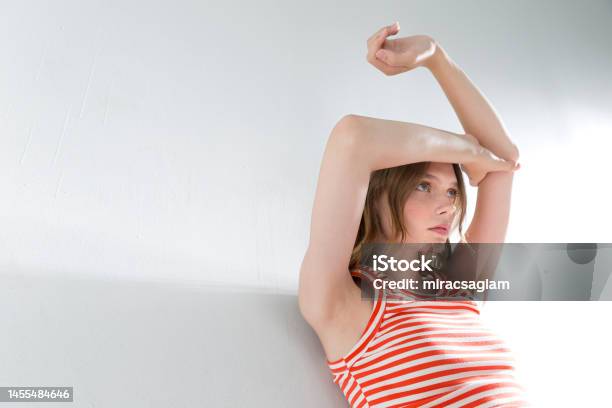 Girl On A White Ba Blonde And Freckled Girl On A White Background Wearing A Striped Orange Tshirtackground Wearing A Shortsleeved Tshirt Stock Photo - Download Image Now