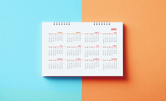 2023 calendar on blue and orange background. Directly above. Horizontal composition with copy space. Calendar and reminder concept.