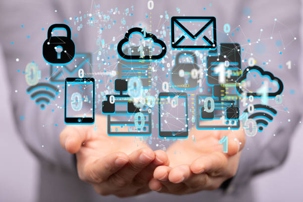 istock Shallow focus of human hands holding various mobile icons, Internet infrastructure concept 1455485782