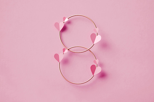 International Women's Day Concept - Hearts Over Gold Colored Circles Forming Number 8 On Pink Background