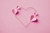 Pink Heart Shapes Over Gold Colored Heart On Pink Background