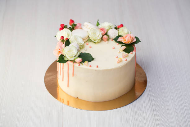 istock Cake with fresh flowers and macaroons. 1455488075