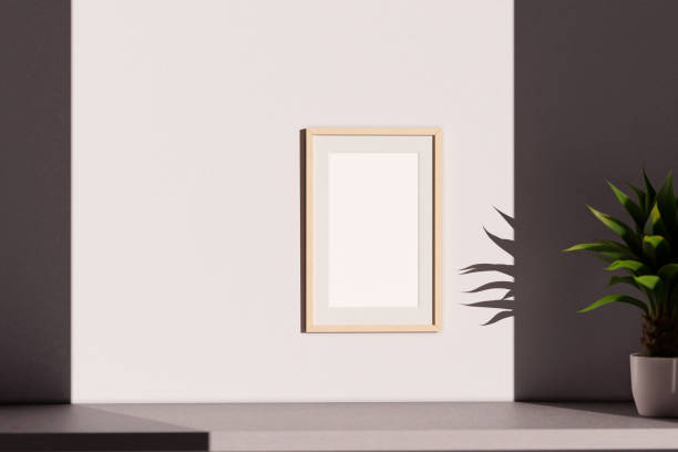 istock Bamboo wooden empty picture frame template, hanging on blank wall with copy space. 1455488138