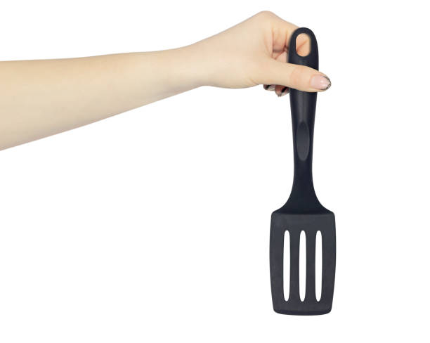 istock plastic kitchen spatula in hand isolated from background, concept of hand over or throw away kitchen spatula 1455488236