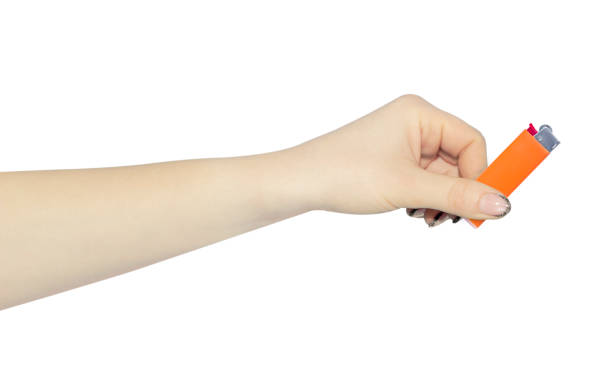 istock lighter in hand isolated from background, concept to pass or throw away 1455488302