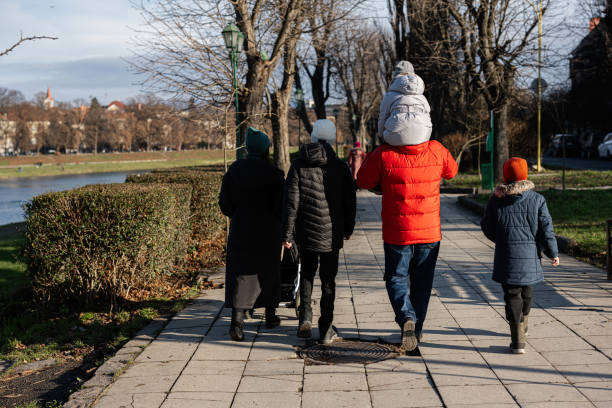 istock Back of family walking at pathway in a park. 1455488582