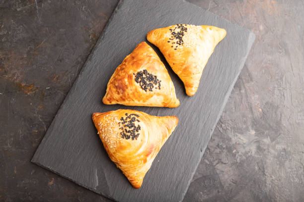 istock Homemade asian pastry samosa on black. top view. 1455489265