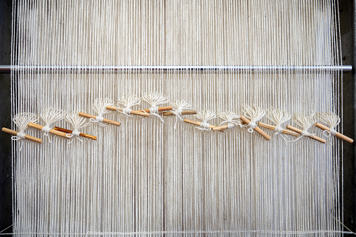 Wool threads prepared and lined up on a weaving loom