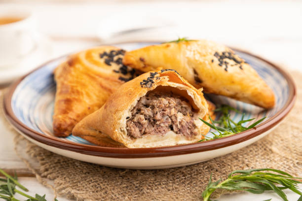 istock Homemade asian pastry samosa on white wooden. side view, selective focus. 1455489550