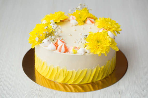 istock Cake with yellow stains, yellow chrysanthemums and meringue. 1455489849