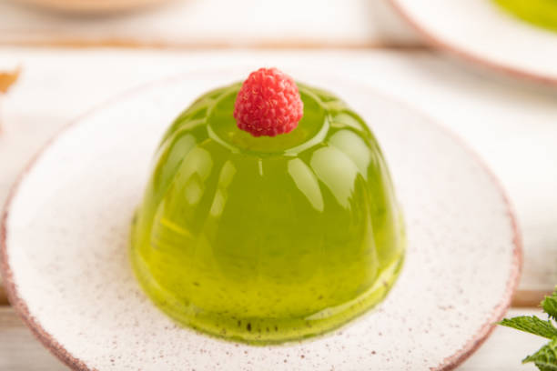 istock Mint and raspberry jelly on white wooden. side view, selective focus. 1455489859