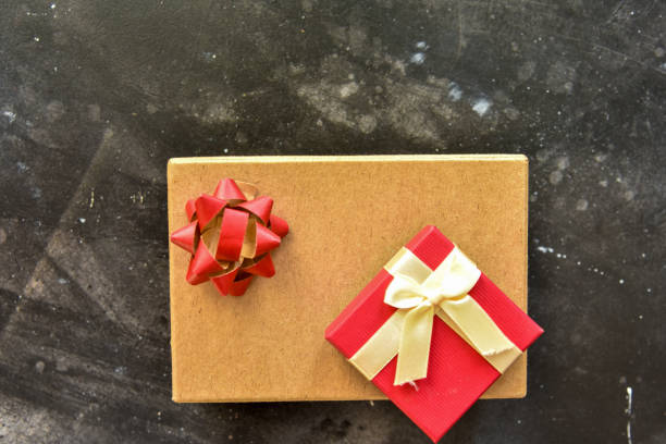 istock Gift  box top view on a  black background, decorated with a textured bow and feathers,creating a romantic atmosphere for anniversary presents,valentine and birthday gift, post cards. Close up, copy space 1455490586