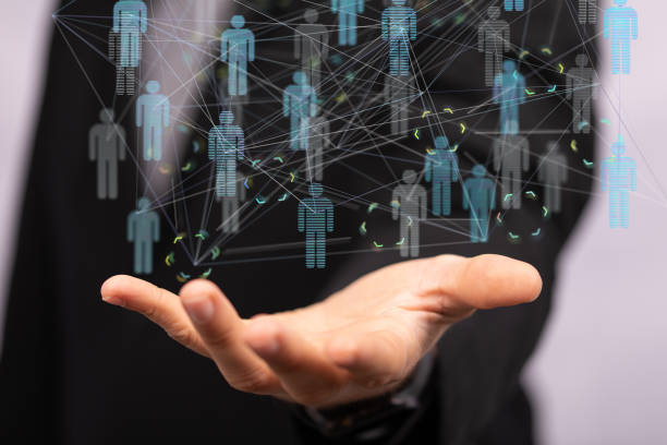 istock Shallow focus of a human hands holding interconnected human icons for networking concept 1455490660